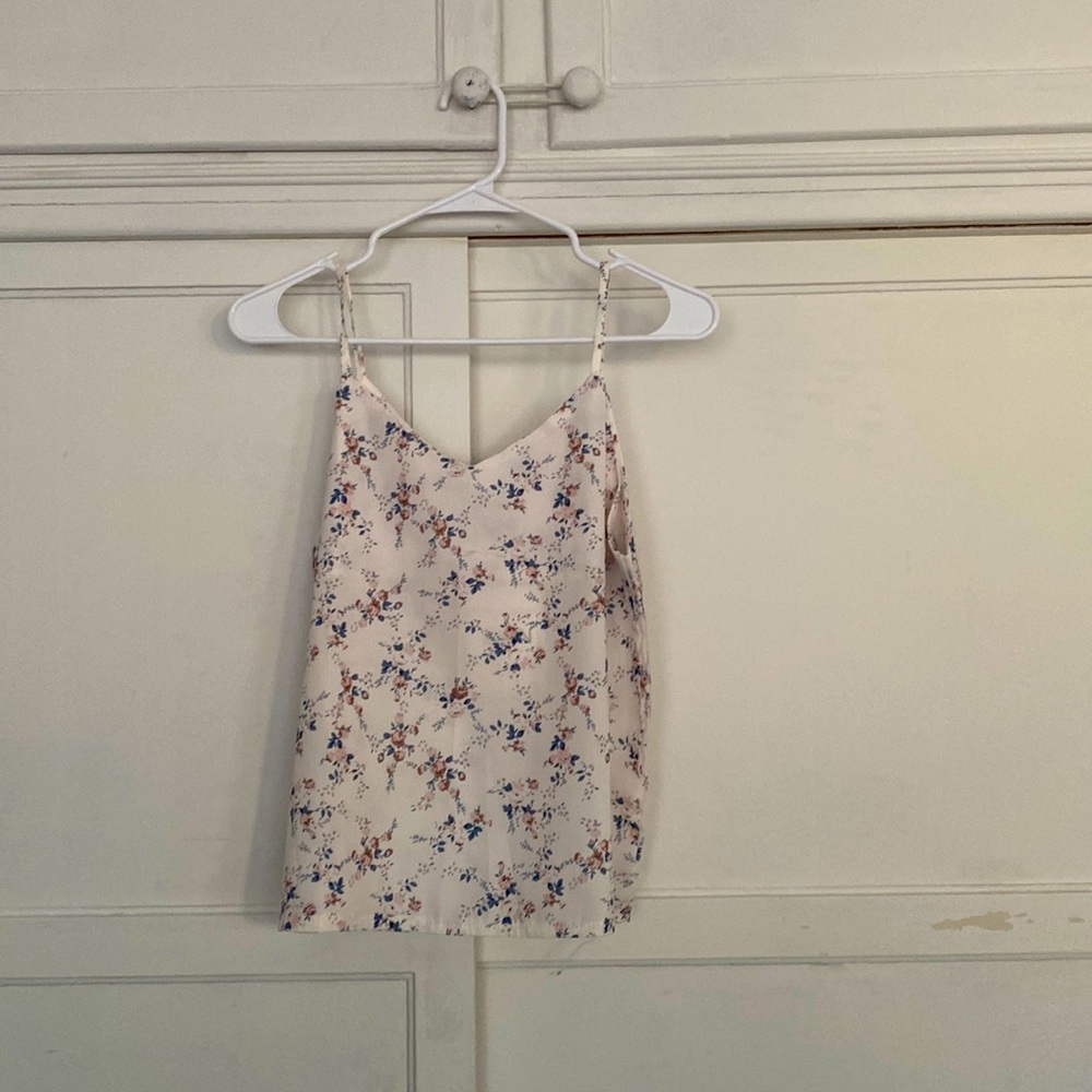Selling cute white top with flowers printed on.